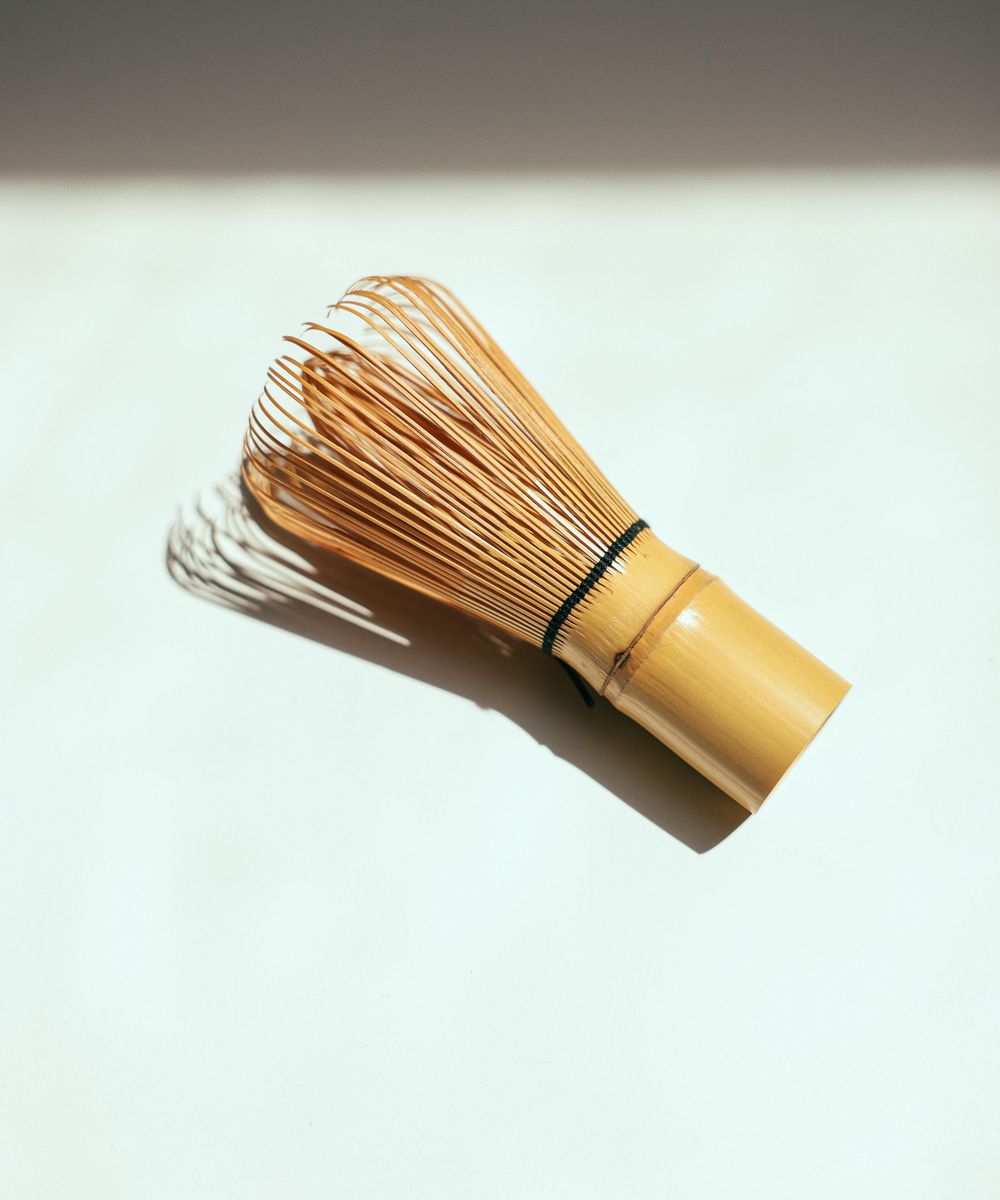 Close-up of a bamboo matcha whisk (chasen)
